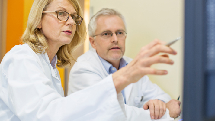 Doctors looking at a screen