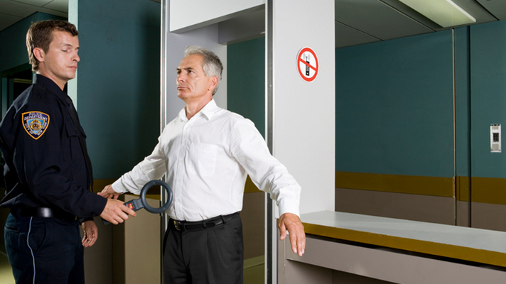 Man going through a hospital safety checkpoint.