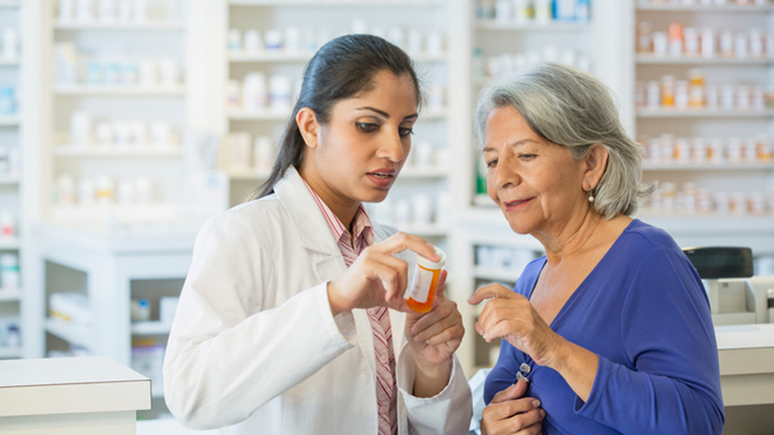 Consumer comparing prices with a pharmacist.