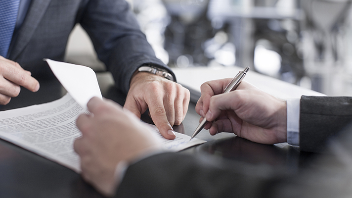 Businessperson signing paperwork