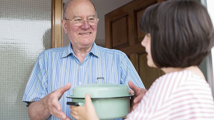 Handing out food to the elderly.