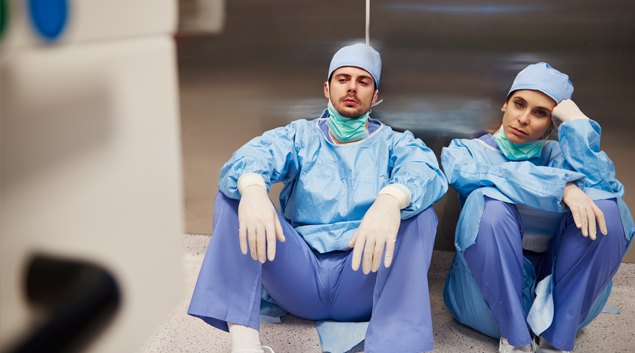 A weary nurse in blue