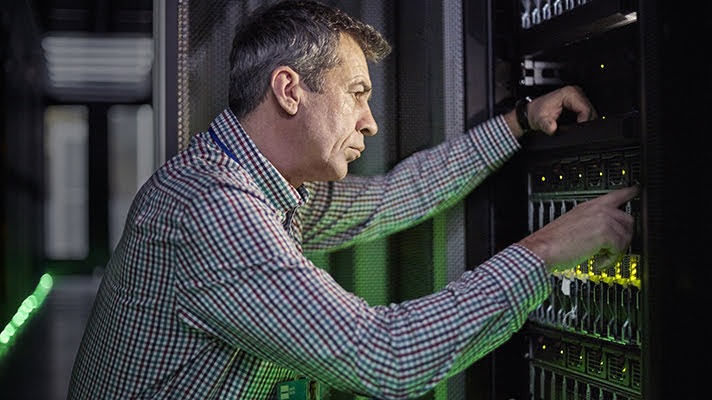 Man working in server room.