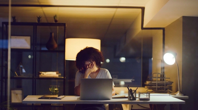 Worker at a computer rubbing eyes