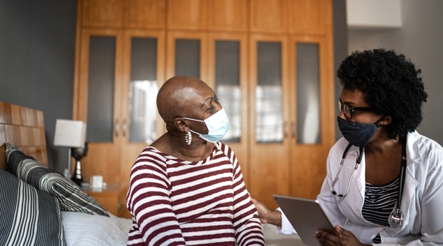 Doctor talking to patient in mask