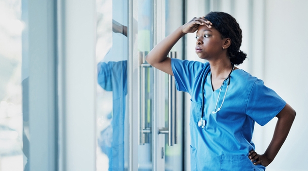 Medical worker starting out of window