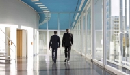 Executives walking away down a hospital hallway