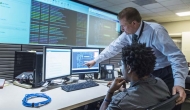 Two workers in a control room