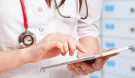 doctor using EHR on tablet