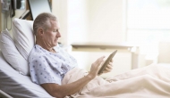 Patient in bed with computer tablet