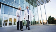 Two medical professionals exit a hospital. Photo: Peter Griffith/Getty Images