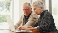 Senior couple search on a computer.