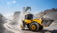 Large construction equipment moving gravel