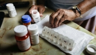 Hands using a pill organizer