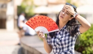 Person fanning self in the heat