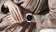 One hand reaches for smartwatch on opposite wrist