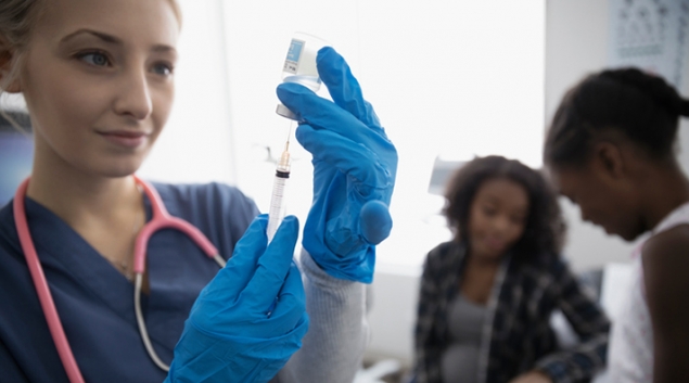 Person preparing a vaccine shot